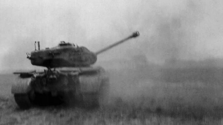 An M26 Pershing firing its gun against German positions in 1945