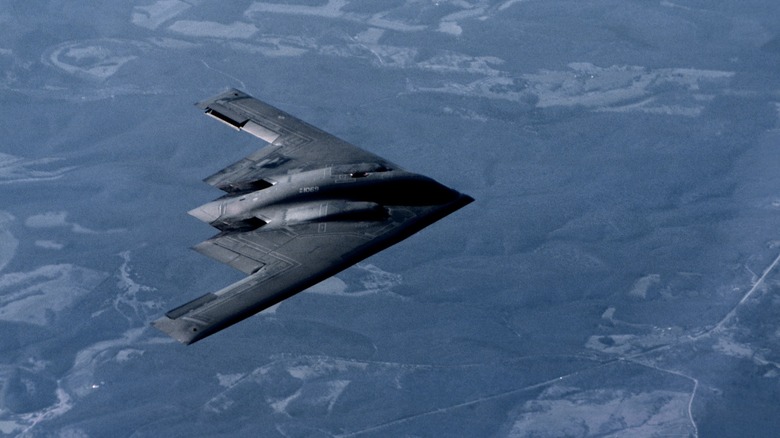 B-2 bomber flying over blue land