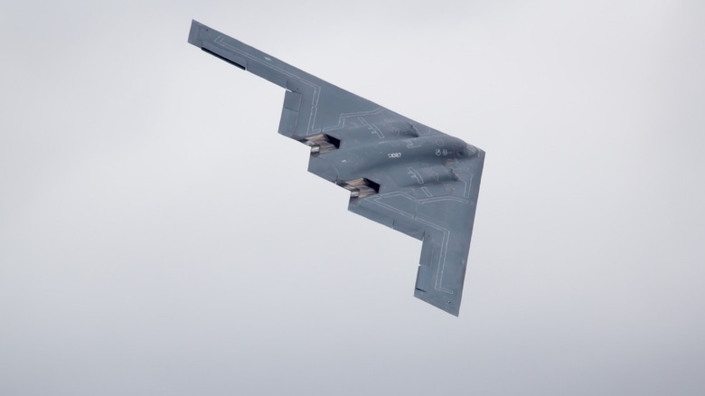 B-2 stealth bomber flying over gray skies