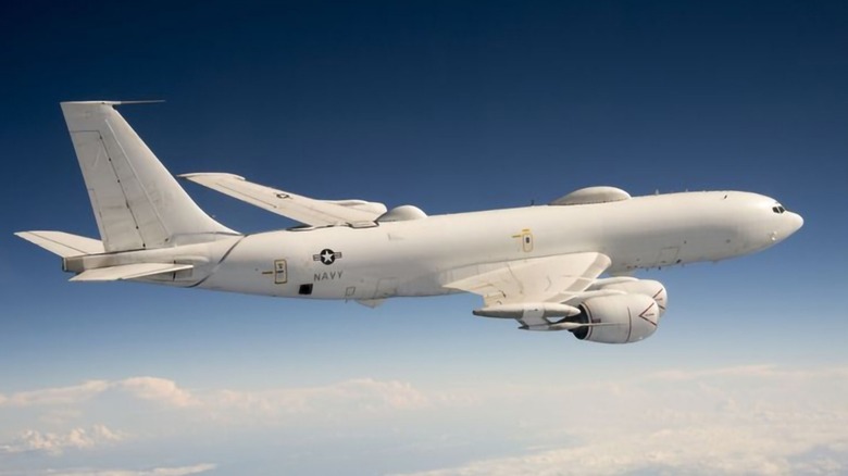 E-6 B Mercury flying in the sky with clouds under it