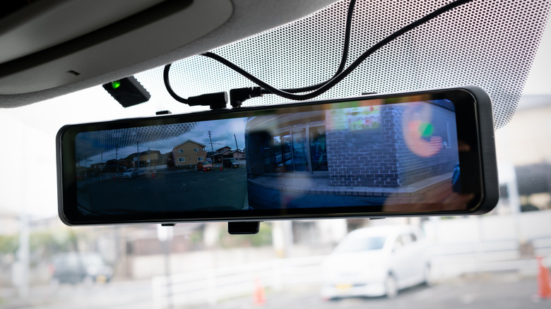 A rear view mirror attached to wires in a car.