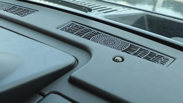 Sunload sensor on a dashboard next to defrost vents