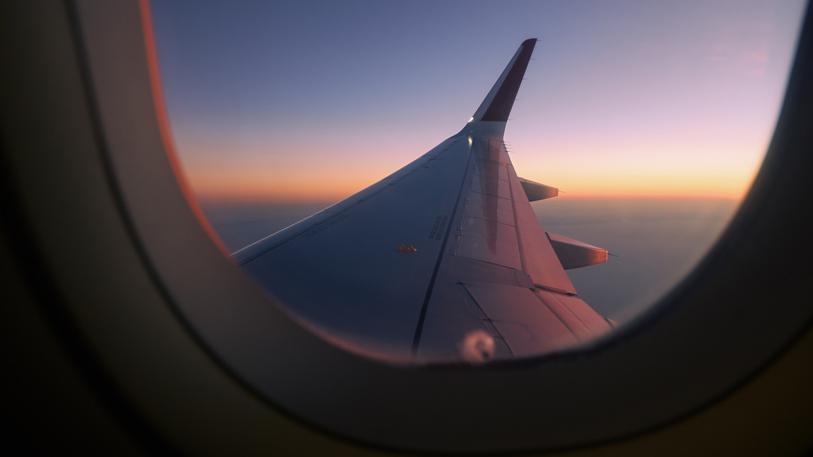 Here's What That Tiny Hole In Airplane Windows Is For