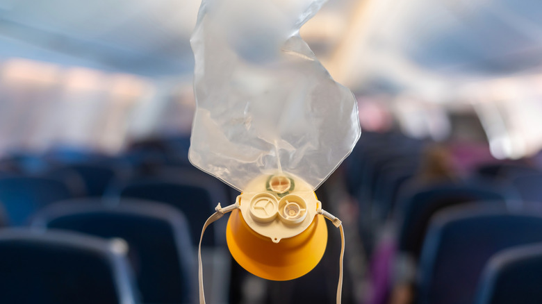 oxygen mask dropping from plane ceiling