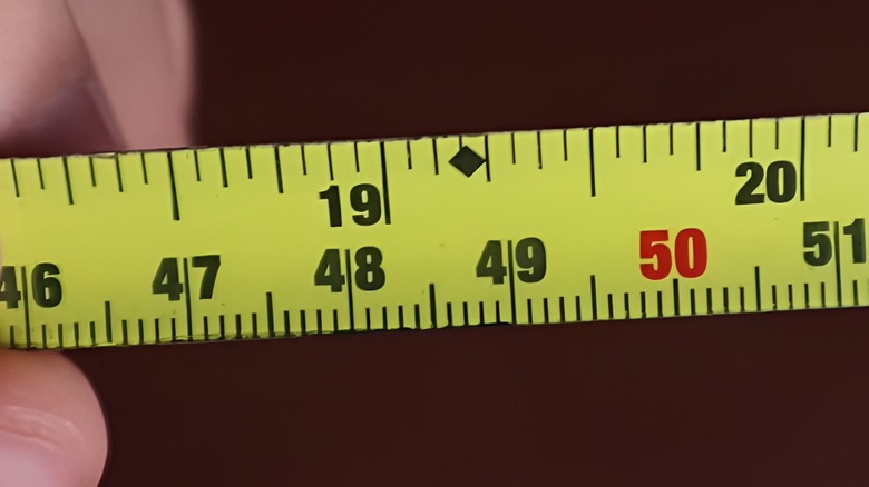 Closeup of tape measure with diamond towards the top