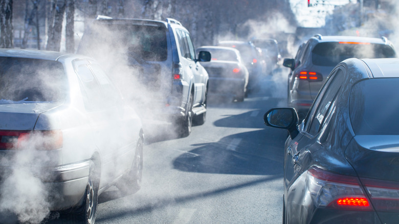 Car Exhaust From Traffic Jam Rising In The Air On A Cold Day