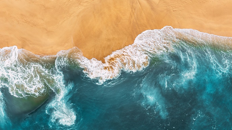 Ocean wave on sandy shore