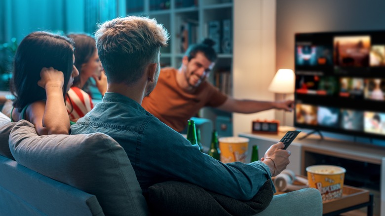 People watching TV in living room