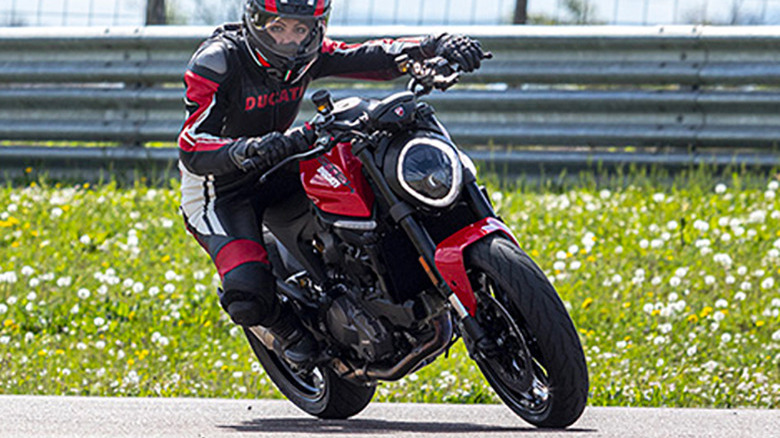 Woman riding red Ducati Monster