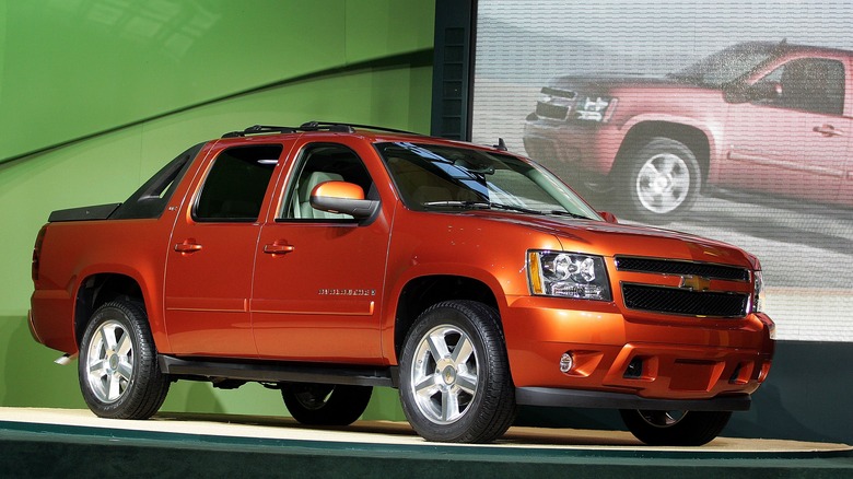 Rust-colored second-gen Chevrolet Avalanche on display platform