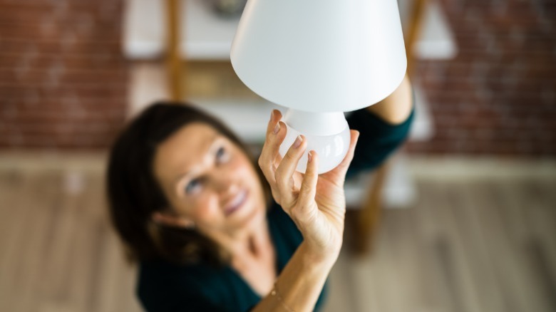 woman installing LED light