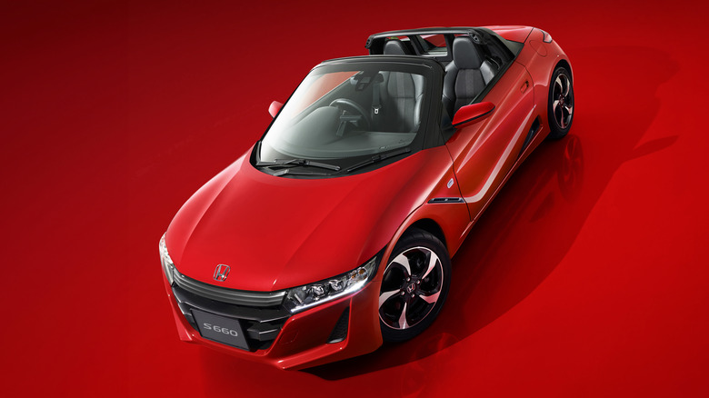 red 2015 Honda S660 on red background