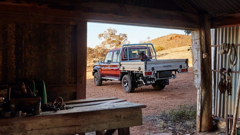 Toyota LandCruiser 70 parked near garage