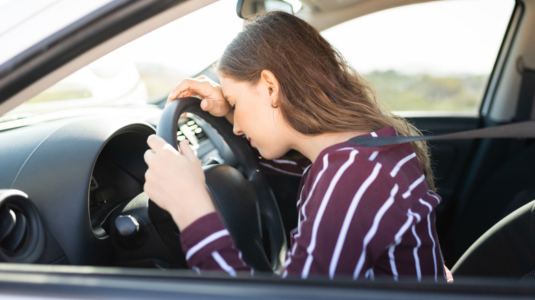 Driver's head and hands on wheel