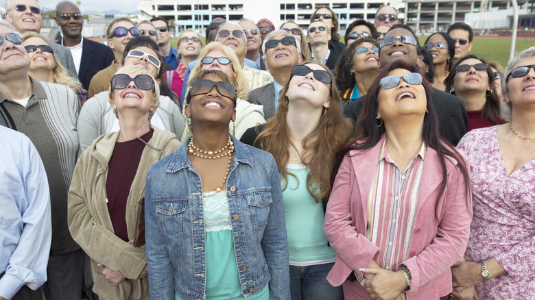 Group of people watching a solar eclipse