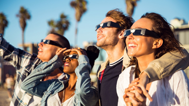 A group of people observing a solar eclipse