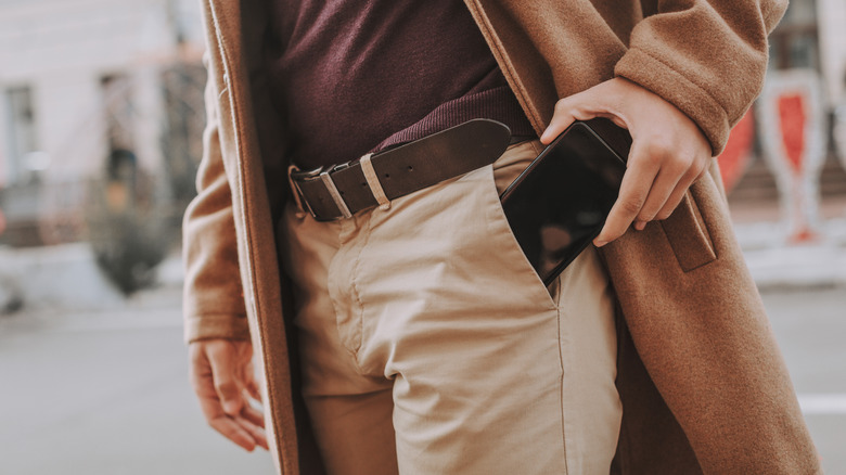 Man pulling phone out of pocket