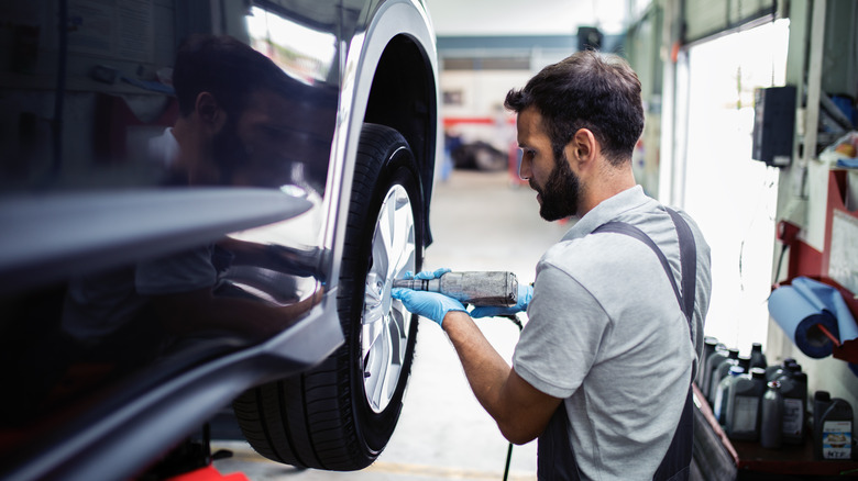 man servicing tires