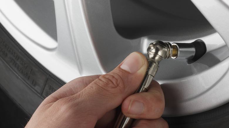 person adding air to tires