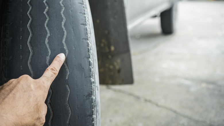 pointing to tire