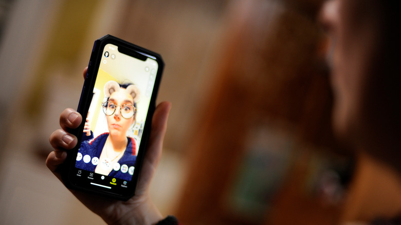 Woman using Snapchat filters