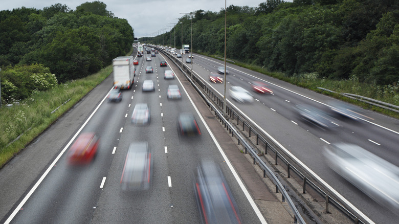 Cars rushing down a freeway.