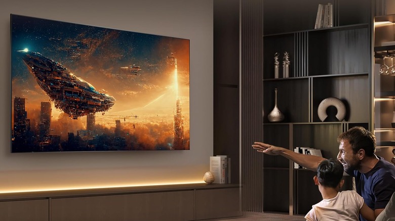 A Hisense U9N series TV in a fancy living room with a man and boy watching.