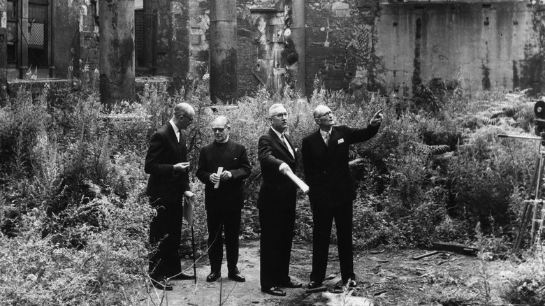 Men tour the remains of St Mary the Virgin church