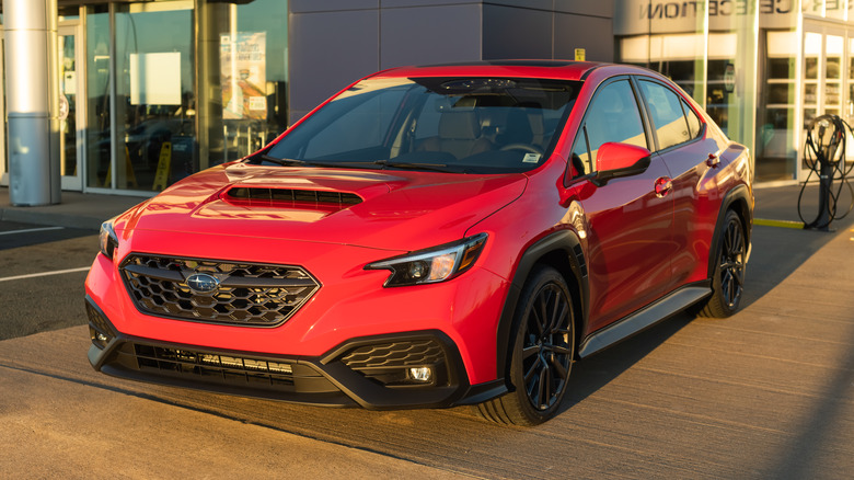 red Subaru car at a dealership