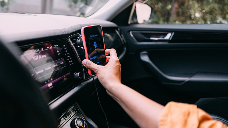 woman placing smartphone on car mount