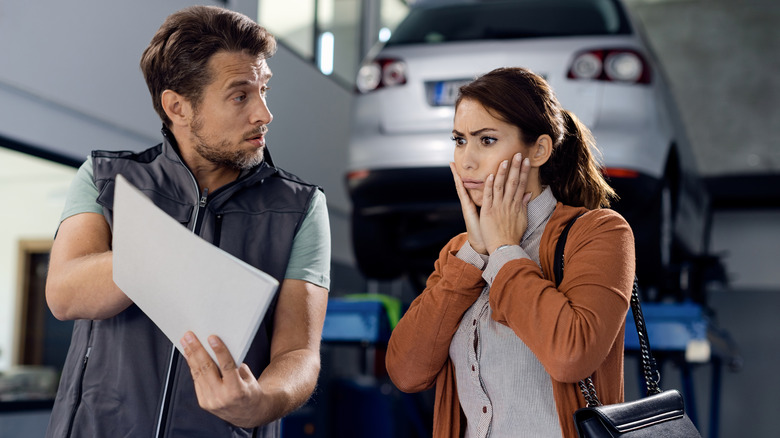 Mechanic Showing Bill To Customer