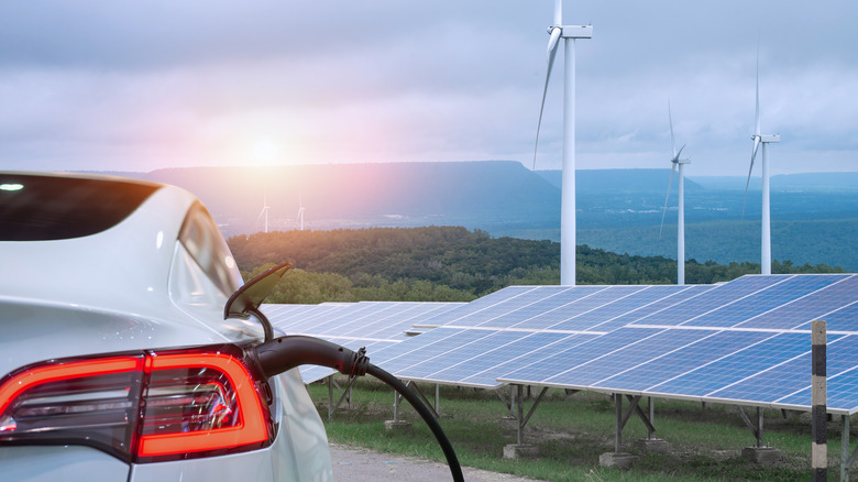 EV charging, solar panels and windmills in background