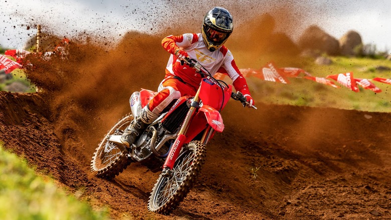 Person racing CRF250R on trail