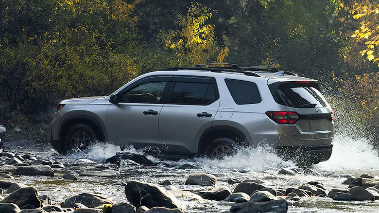 Silver 2025 Honda Pilot TrailSport driving through creek