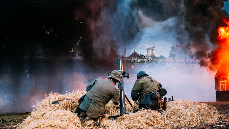 Reenactment soldiers firing mortar