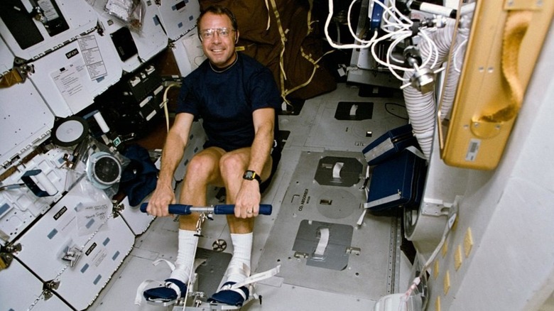 astronaut using a rowing machine