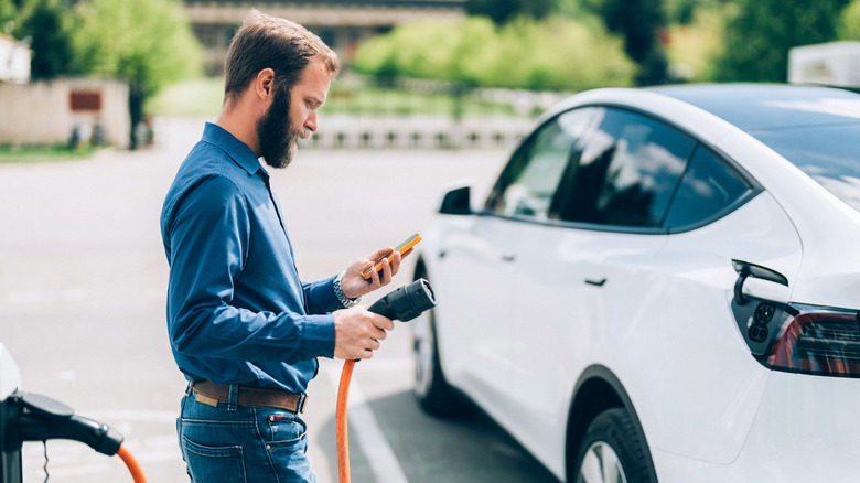 Person charging an electric car