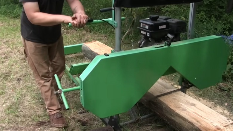 Person using bandsaw saw mill