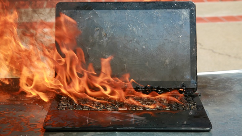 A laptop melting and on fire.