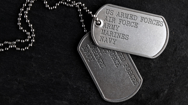 Generic U.S. military dog tags over a black background