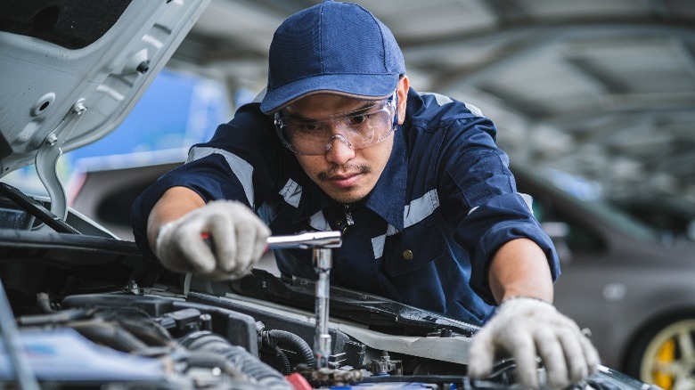 a mechanic repairing an engine