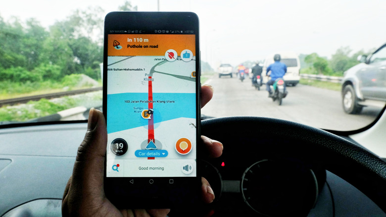 The Waze app displaying traffic congestion and a pothole on the road.