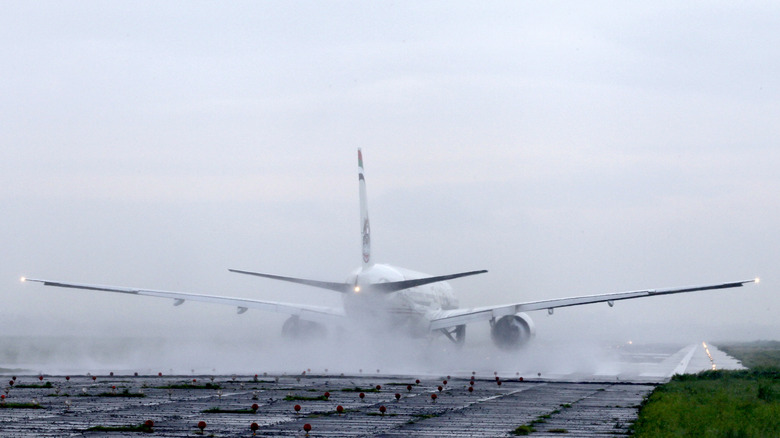 An Etihad Airways Boeing 777-3FXER A6-ETI taking off from a rain-splashed runway at  Hazrat Shahjalal International Airport, Dhaka, Bangladesh.