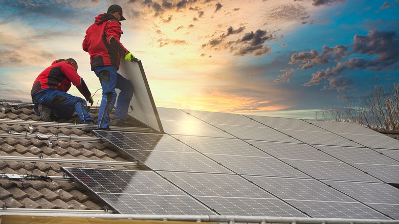 People installing solar panels