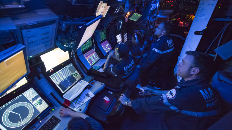 Submariners sitting in front of computer consoles