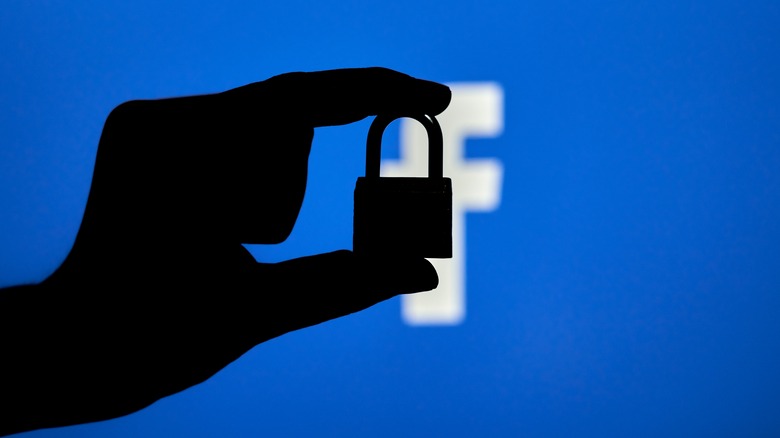 Silhouette of lock with Facebook logo in background
