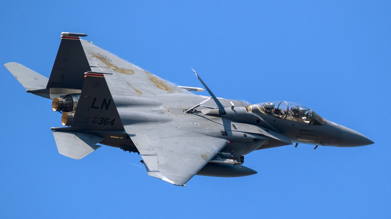 The F-15E Strike Eagle flying over blue skies