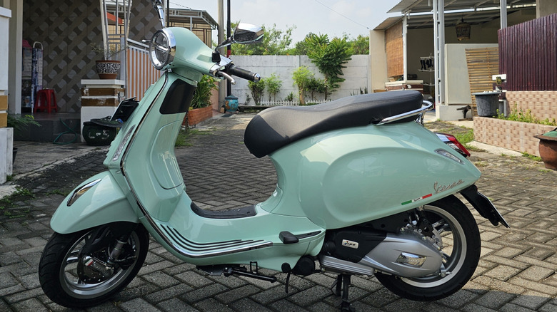 A Vespa parked on a path