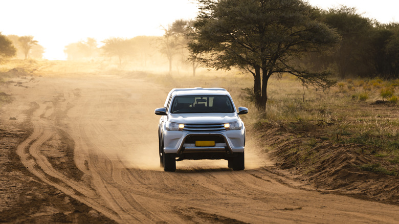 Four-wheel drive vehicle driving fast on a dirt road