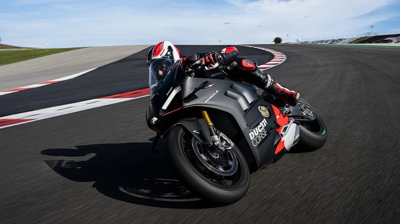 A man racing on a track with black Ducati Panigale V4